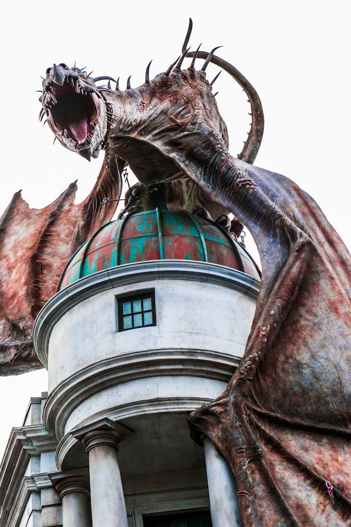 journey A dramatic dragon statue towers over a building at an Orlando theme park, USA.