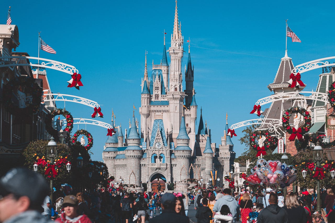 team-02 A busy day at Orlando's Magic Kingdom with crowds enjoying holiday decorations.
